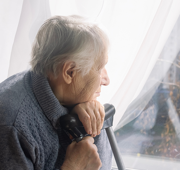 Dame âgée devant sa fenêtre