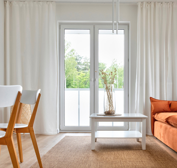 Porte-fenêtre PVC blanche dans un salon moderne et lumineux